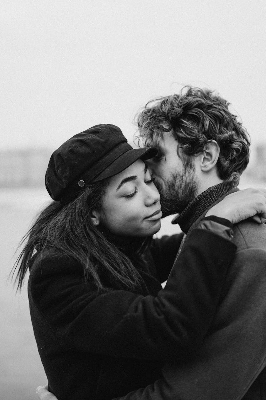 monochrome photo of man kissing woman things to look for when dating a masculine man, signs of a masculine man, how to know if he’s husband material, masculine man traits, feminine woman dating tips, what to look for in a man for marriage, masculine vs feminine energy in relationships, dating advice for women, high value man qualities, relationship red flags, masculine energy signs, dating masculine men, wife material tips, feminine energy attraction, marriage advice for women, qualities of a good husband, strong masculine man traits