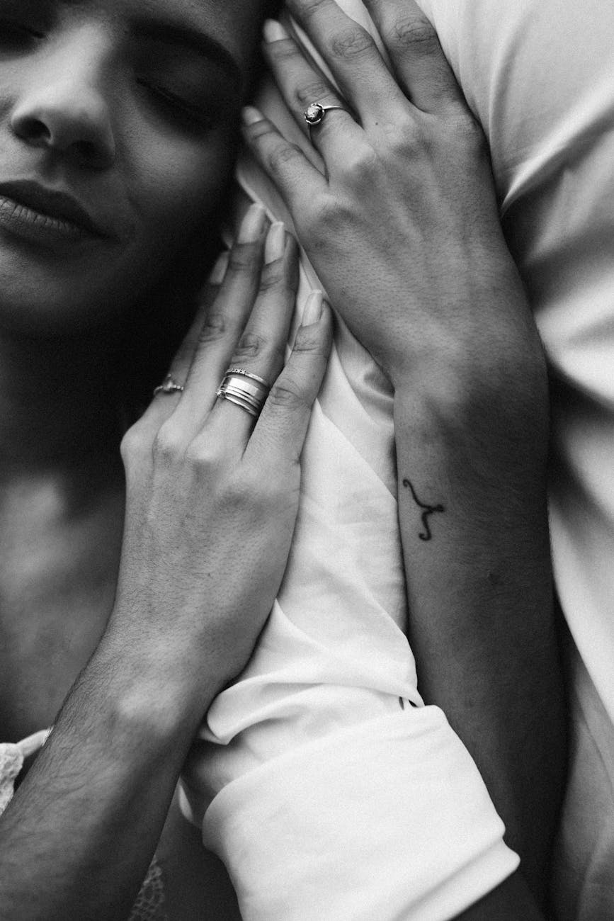monochrome photo of woman s hands with tattoo