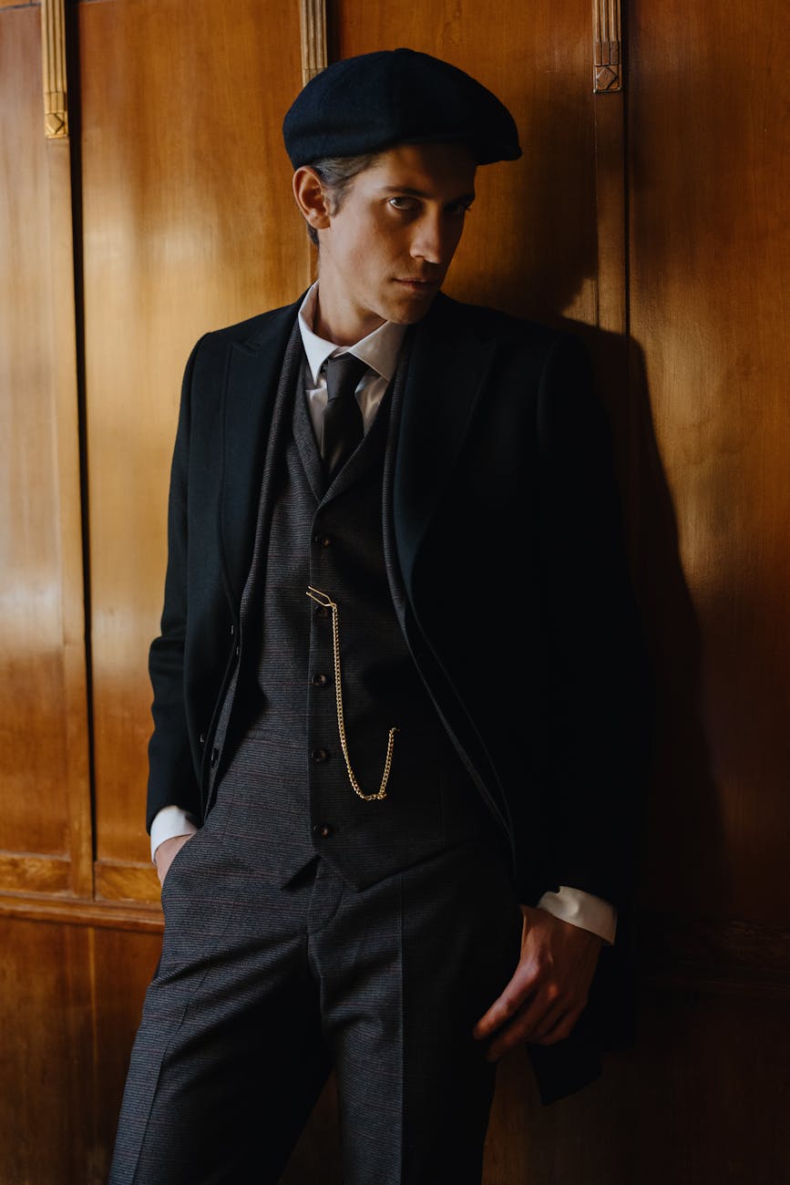 man in black suit and flat cap dating high-value men, financially struggling man, self-made man vs daddy’s boy, dating advice for women, spotting ambition in men, evaluating character in relationships, high-value provider types, relationship tips for women, navigating dating a provider, dating smart, love over money, choosing the right partner, setting boundaries in relationships, mutual growth in dating, building legacy with partner, high-value relationships guide, dating men with potential, understanding provider types, wealth vs character in dating, It Girl School dating advice